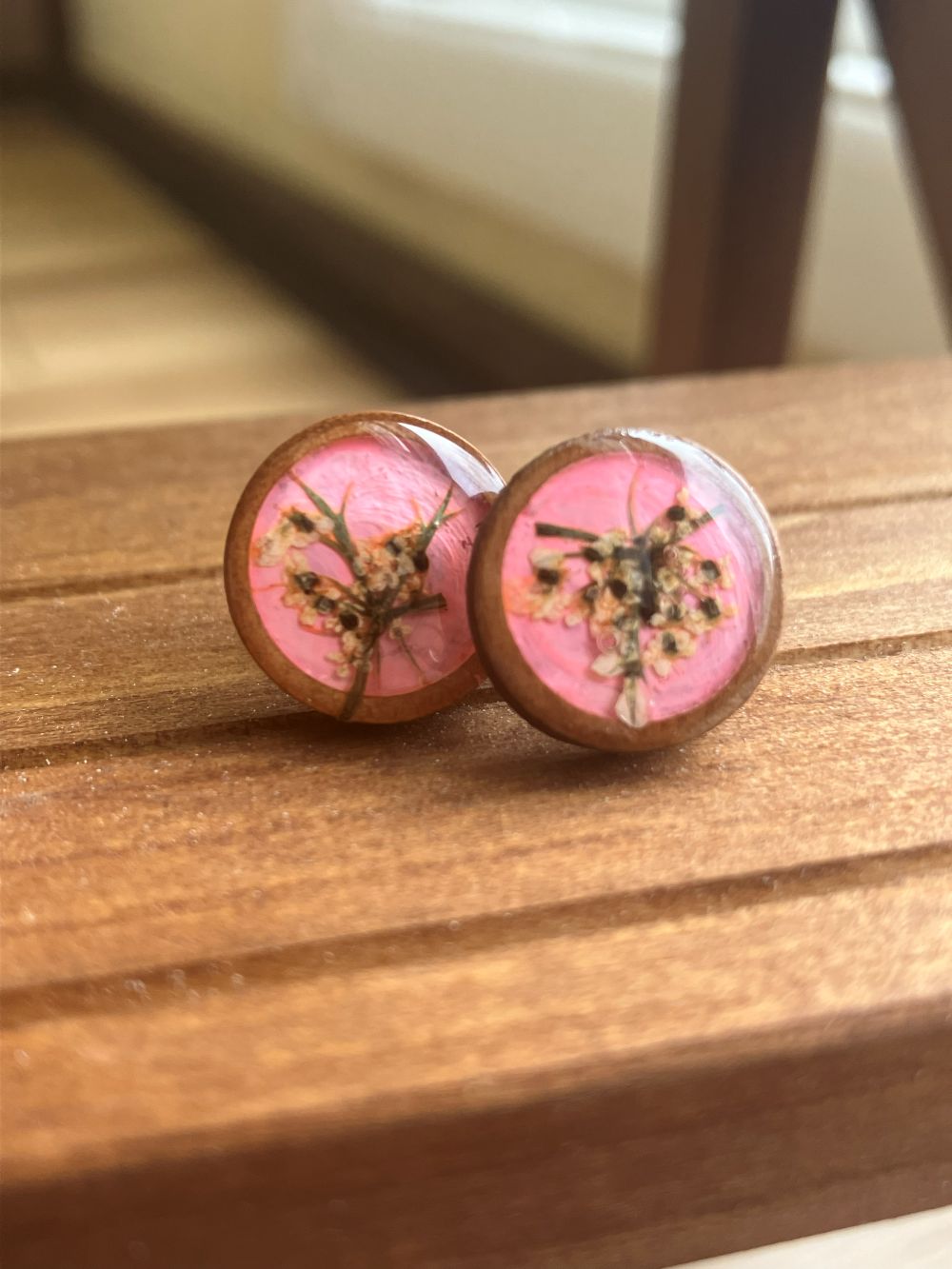 Hot pink wooden stud earrings encasing real Queen Anne’s Lace flowers handmade by R & D Floral.